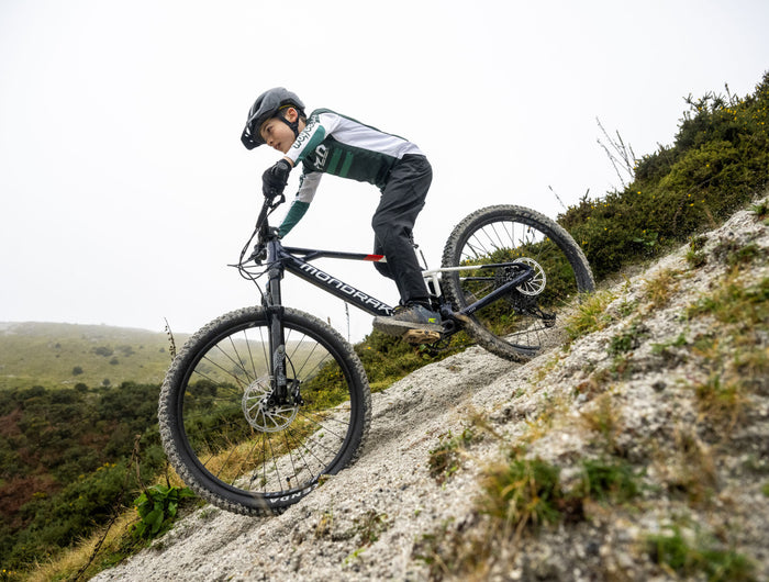 Person riding a Mondraker Kids Electric Mountain Bike downhill