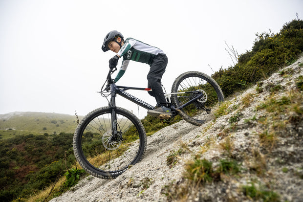 Person riding a Mondraker Kids Electric Mountain Bike downhill
