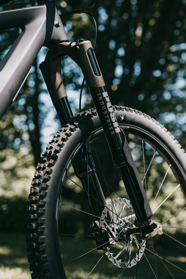 A gold Push Industries inverted mtb fork 