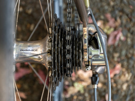 Close-up of a bicycle gear system with 'DuraAce' branding.